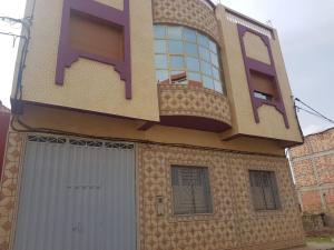 a large house with a large building with a garage at cap bouya in Aït Farts