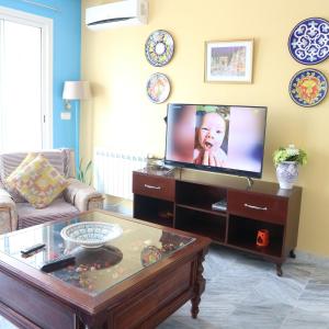 a living room with a tv and a coffee table at The Pearl Apartment Hammam Sousse WIFI in Sousse
