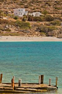 a dock in the water next to a beach at Albatros Studios & Apartments in Lefkos Karpathou