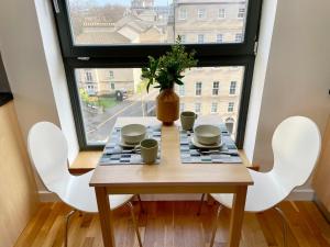 a table in a room with a window at Edinburgh Penthouse 101 in Edinburgh +22 photos