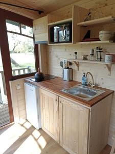 a kitchen with a sink and a counter top at Roulottes Les Alpaguettes in Saint-Romain-de-Benet