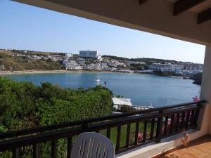 a balcony with a view of a body of water at Apartamentos Arco Iris in Punta Grossa