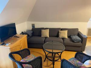 a living room with a couch and chairs and a table at S-apartment Wiedweg in Wiedweg