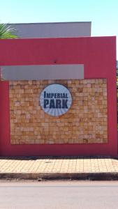 a sign for an imperial park on a brick wall at Imperial Park in Cornélio Procópio