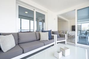 a living room with a couch and some windows at Halcon Deluxe 5-A in Benidorm