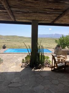 a person sitting in a chair on a patio at 3 ALOES GUESTHOUSE in Uis