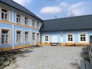 a large blue building with a lot of windows at Hostinec u Klačkov in Lubina