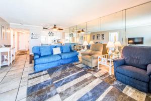 a large living room with blue couches and chairs at Moonspinner 211B in Panama City Beach