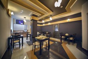 una sala da pranzo con tavoli e sedie in un ristorante di Continental Hotel a Kutaisi