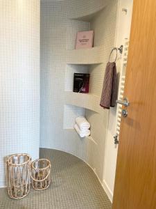 a bathroom with a walk in shower with towels at Edinburgh Penthouse 101 in Edinburgh