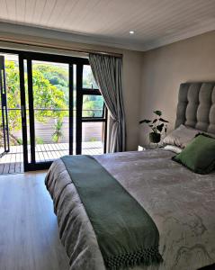 a bedroom with a large bed with a large window at Sea you on Sands in Wilderness +52 photos