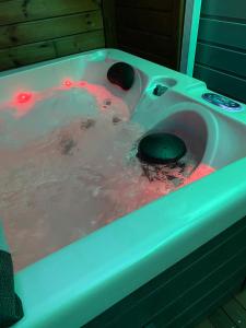 a bath tub with red lights in it at Les Lodges de Malendure in Bouillante