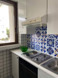 a kitchen with blue and white tiles on the wall at La Fenice sulla spiaggia in Gallipoli