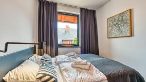 Posteľ alebo postele v izbe v ubytovaní Apartament Triventi 98 z Widokiem- 5D Apartamenty