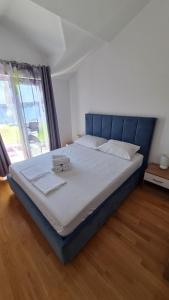 Postel nebo postele na pokoji v ubytování Apartmani Ferdi