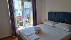 Postel nebo postele na pokoji v ubytování Apartmani Ferdi