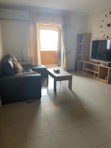 a living room with a couch and a table at Ohana in Morro del Jable