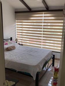Postel nebo postele na pokoji v ubytování Casa comoda, bien ubicada en conjunto con piscina