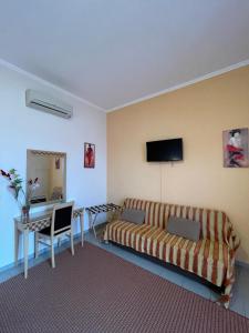 a living room with a couch and a table at Entheon Rooms in Marathopoli