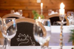 a table with a chair with a dragon drawn on it at Berghotel Jochgrimm - Your Dolomites Home in Varena