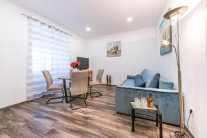 a living room with a blue couch and a table at Apartment Mia in Dubrovnik +23 photos