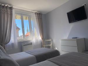 Postel nebo postele na pokoji v ubytování Hôtel de la Plage