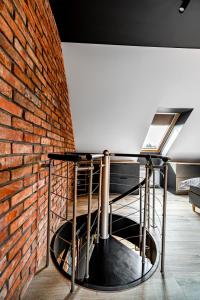 a brick wall and a table in front of a brick wall at BanApart Exclusive Apartments in Zgorzelec
