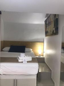 Postel nebo postele na pokoji v ubytování Hotel Hernández CTG