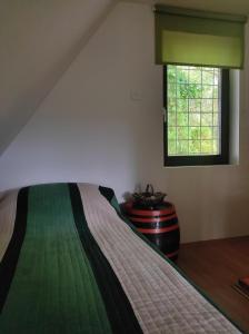 a bedroom with a bed and a window at Green Paradise in Visoko