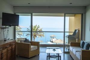 a living room with a view of the ocean at Condominio Nuevo Paracas in Paracas