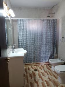 a bathroom with a sink and a toilet and a shower at Casa Piedra Blanca in Cachí +7 photos