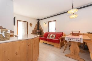 a kitchen and living room with a table and a couch at Miralago in Alleghe +22 photos