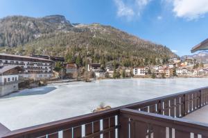 a view of a frozen lake from a balcony at Miralago in Alleghe