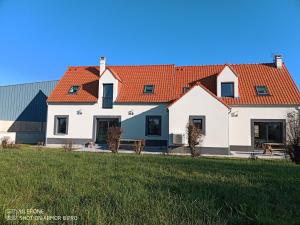 uma grande casa branca com um telhado laranja em au coeur des caps 2 em Audinghen