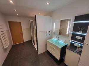 a bathroom with a sink and a mirror at Haus Mika in Cochem +34 photos