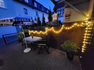 a patio with a table and lights on a wall at Haus Mika in Cochem