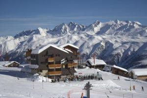 a ski lodge on top of a snow covered mountain at Hotel Jungfrau in Fiesch