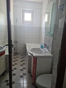 a bathroom with a sink and a toilet at Apartament Mario Forty in Mangalia