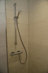 a shower with a shower head in a bathroom at Ferienwohnung Die Alte Schule in Daun +39 photos