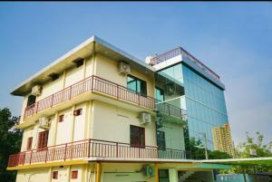 a building with balconies and a glass building at Kalapurayil Residency in Kakkanad