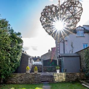 a heart shaped sculpture in the yard of a house at Quirky Kendal Cottage in Kendal