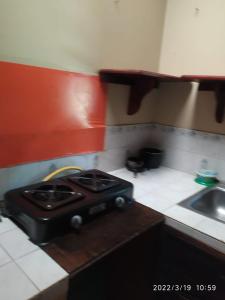a kitchen with a stove and a sink at Don Ramirez in Leticia