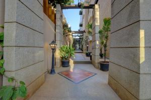 an internal courtyard of a building with potted plants at Sterling Keys by TGI in Bangalore