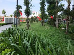 a park with red flags in the grass at SAOLA Apartment FAMILY in Hai Phong