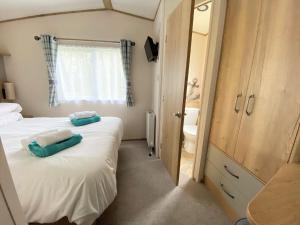 a bedroom with a bed with two pillows on it at Bellevue in South Cerney
