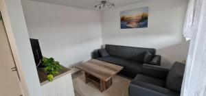 a living room with a couch and a table at Ferienhäuser Steffi und Ruth in Ueckeritz