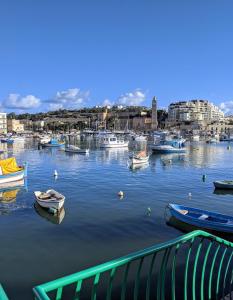 a group of boats sitting in a harbor at Silia's Maisonette in Marsaskala