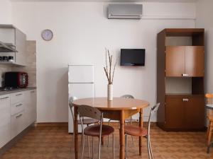 een keuken met een tafel en stoelen in een kamer bij sedicipassi in Villaggio Azzurro
