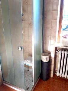 a shower with a glass door in a bathroom at One bedroom appartement with balcony and wifi at Monterosso Grana in Levata