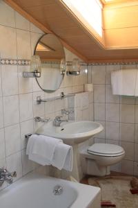 a bathroom with a sink and a toilet and a mirror at Lackenhof in Rauris